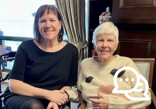 Nikki and her mother sitting in chairs smiling for a photo.
